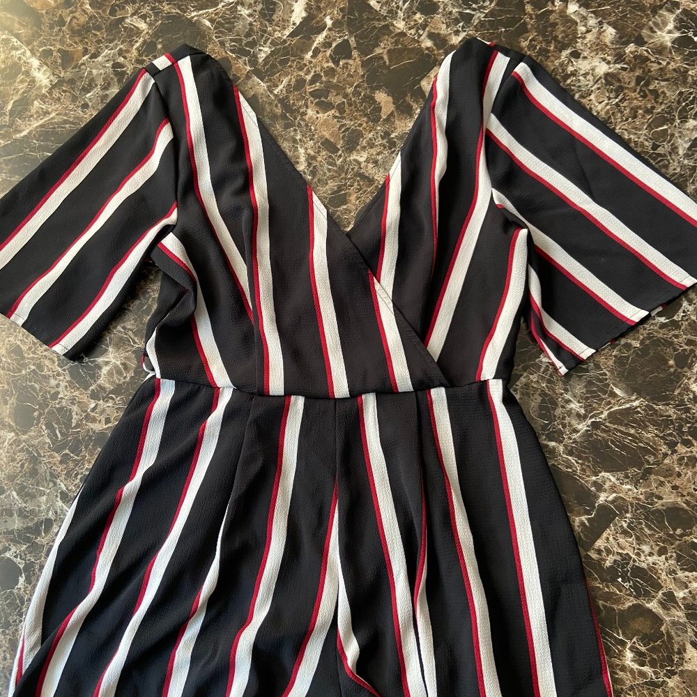 A black romper with red and white stripes.